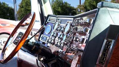 The dashboard of a Freightliner Cascadia at a truck stop