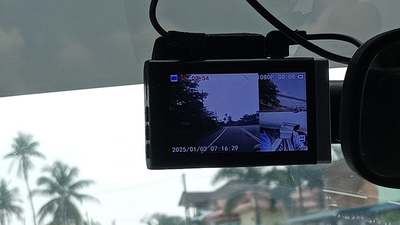 A dash camera mounted at a windshield