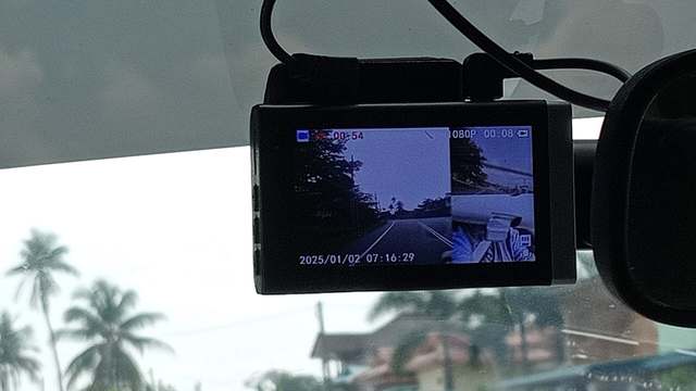 A dash camera mounted at a windshield