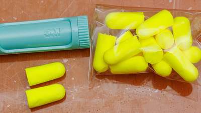 Yellow foam earplugs on a white background