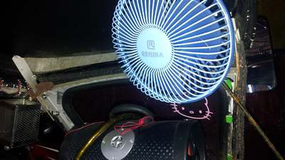A small 12 volt fan mounted on a vehicle