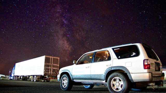 A night sky over a dark landscape