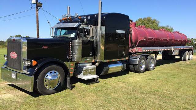 A red Peterbilt 379 parked at a truck show