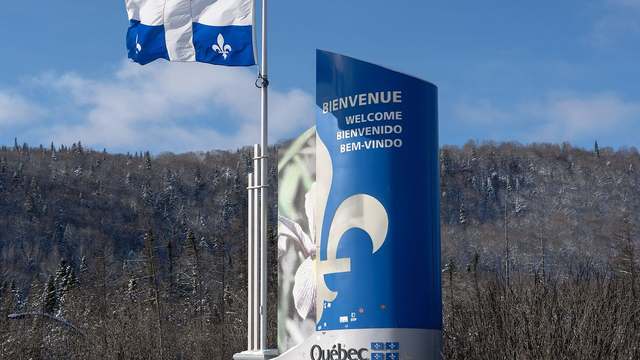 A Bienvenue au Québec sign on the Trans-Canada Highway at the New Brunswick border