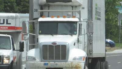 A refrigerated semi-trailer behind a highway tractor