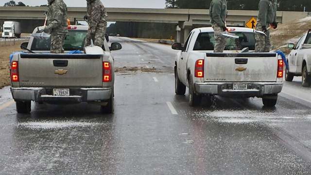 A highway truck spreading salt in winter