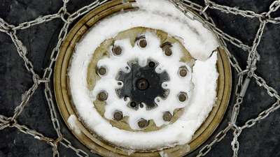 Metal tire chains laid out for a truck