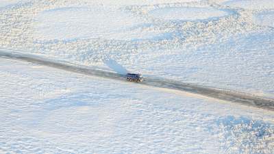 A truck on a snow-covered highway