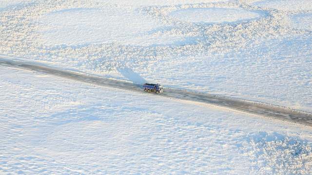 A truck on a snow-covered highway